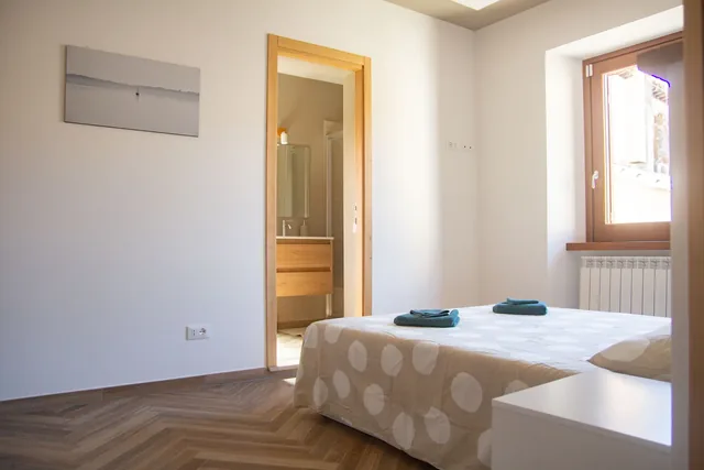 The holiday home’s double bed and adjacent bathroom